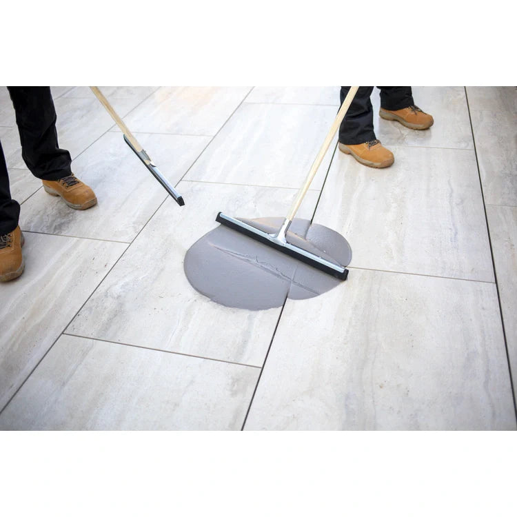 A bucket of EASYGrout for porcelain and ceramic paving with a color sample on the corner.