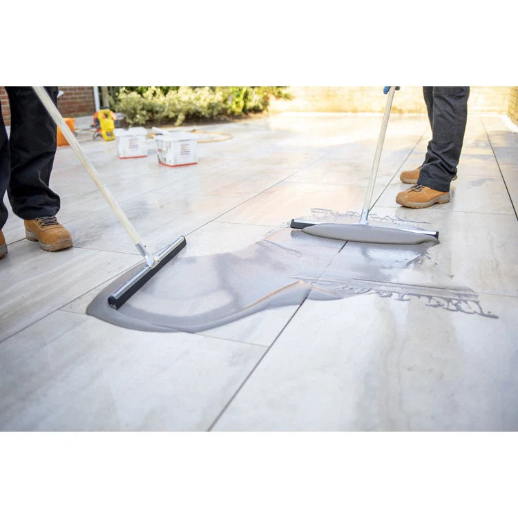 A bucket of EASYGrout for porcelain and ceramic paving with a color sample on the corner.