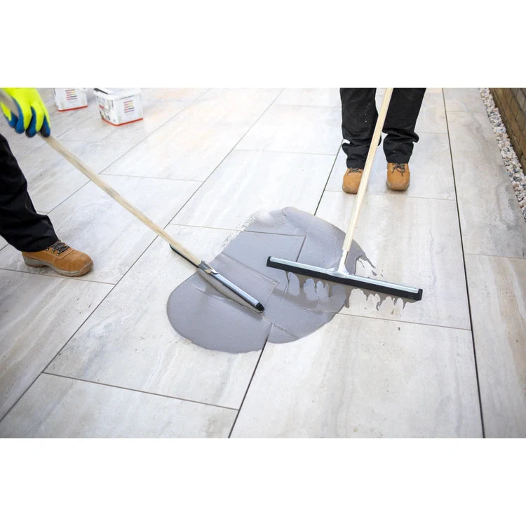 A bucket of EASYGrout for porcelain and ceramic paving with a color sample on the corner.