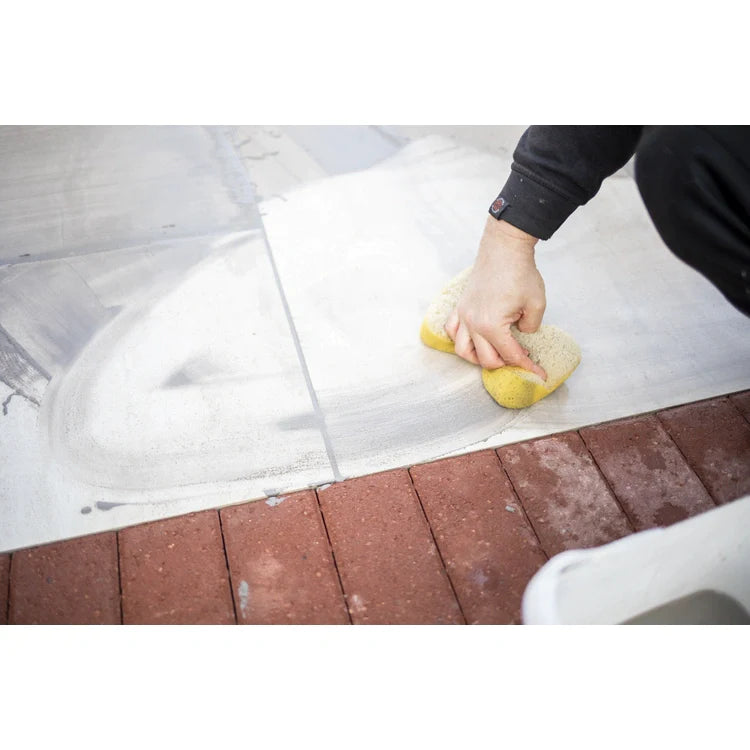 A bucket of EASYGrout for porcelain and ceramic paving with a color sample on the corner.